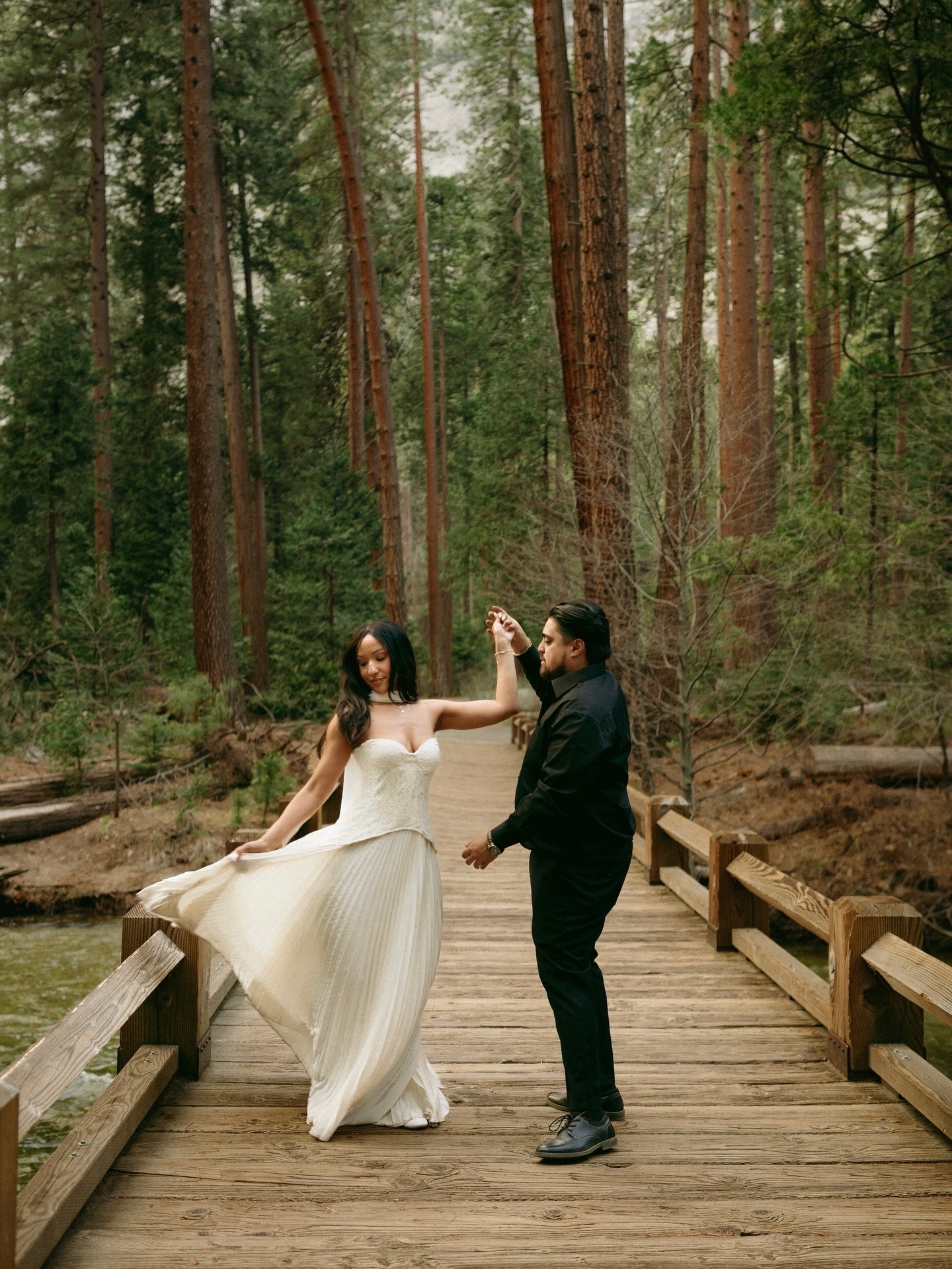 Tamara and Christian dancing on a wooden bridge in Yosemite