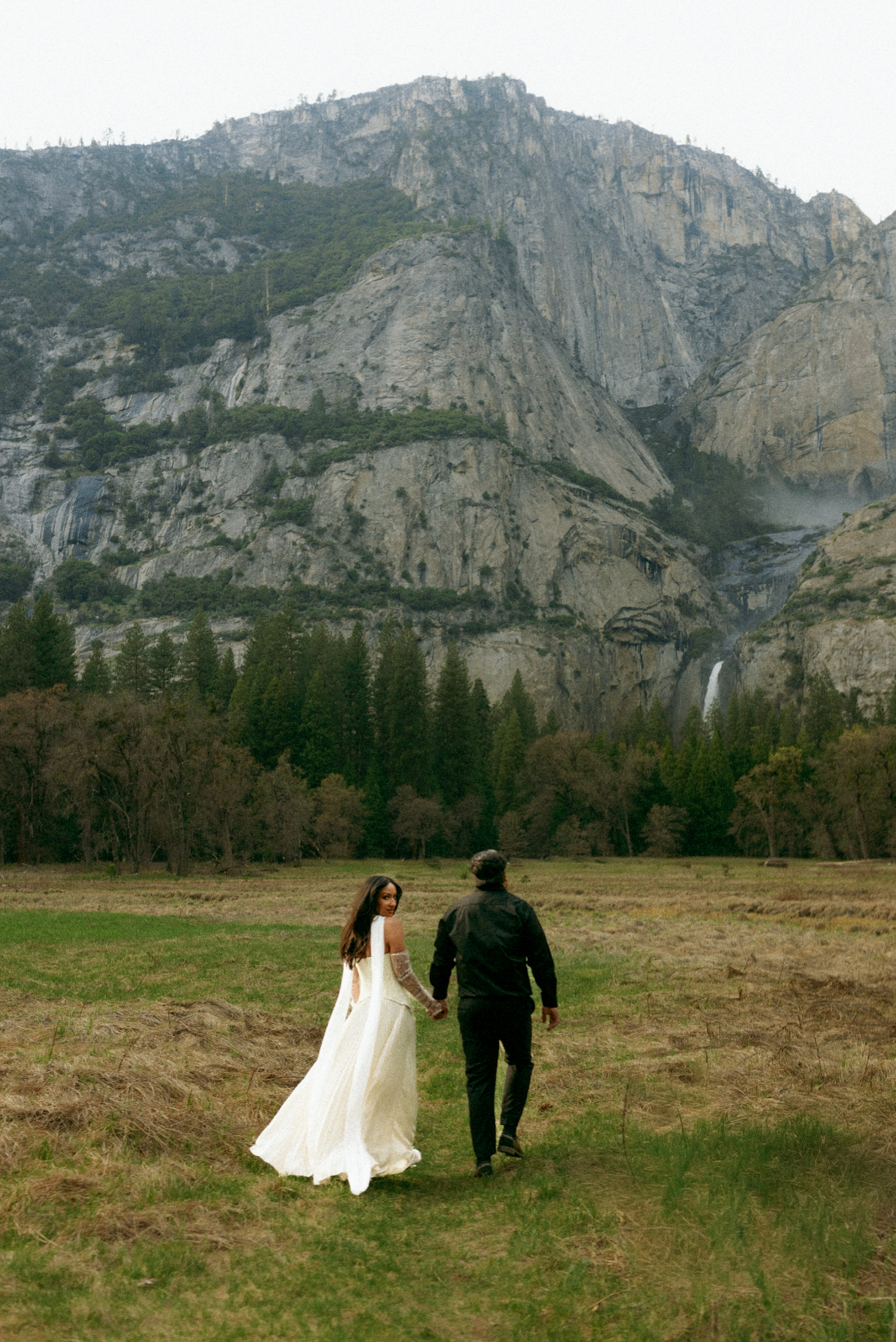 Tamara and Christian walking hand in hand toward Yosemite Falls